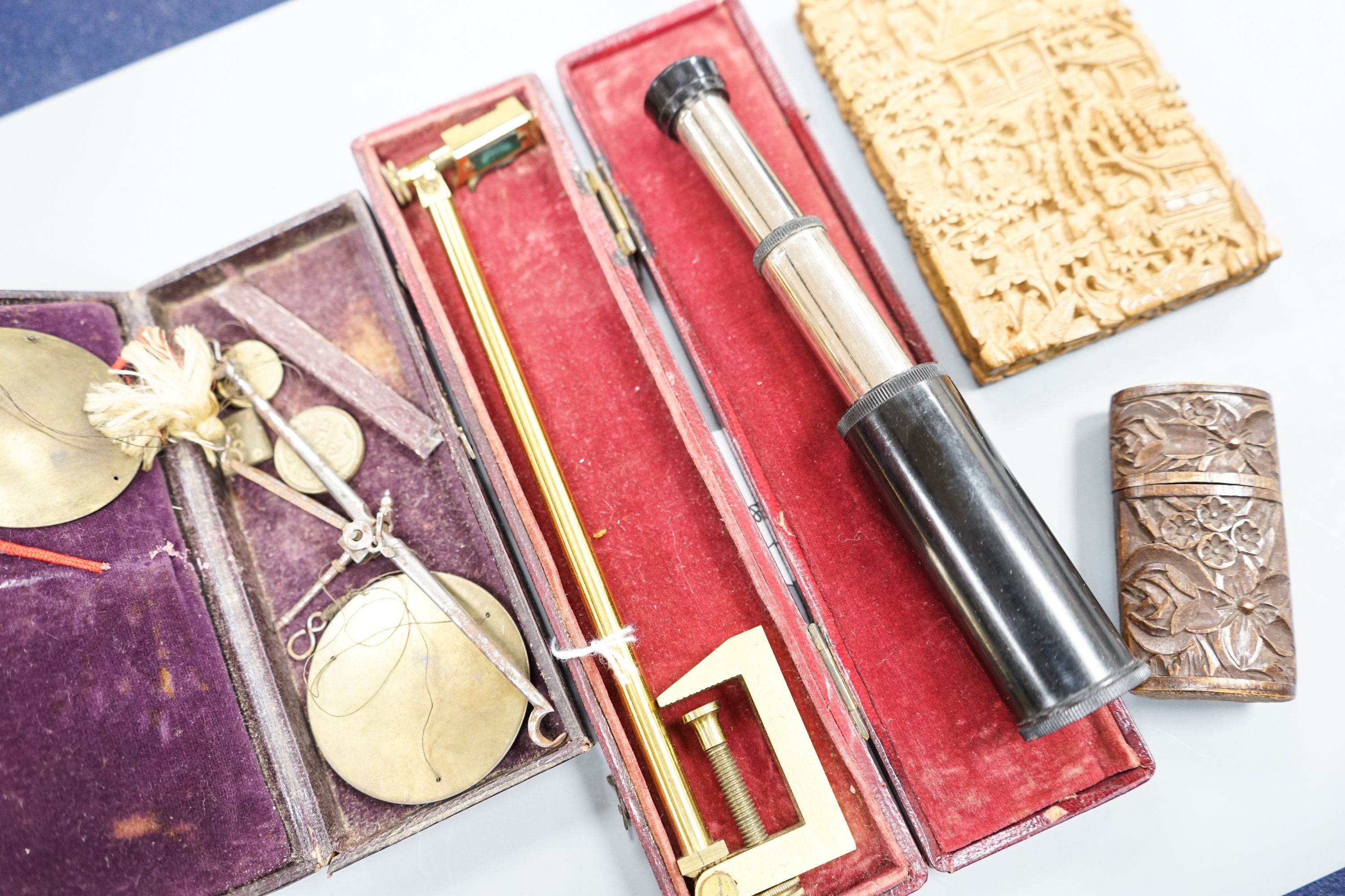 A Chinese carved sandalwood card case, a cased set of Avery gold scales, a Zonex telescope, a cased Cary prismatic instrument and a floral carved wood box.